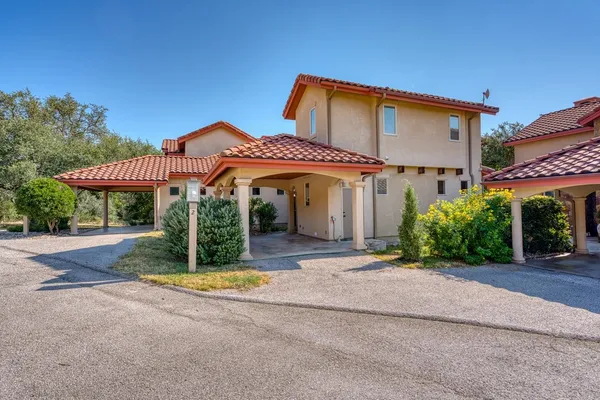 a front view of a house with yard and glass windows