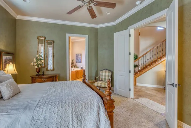 a bedroom with a bed and a chandelier