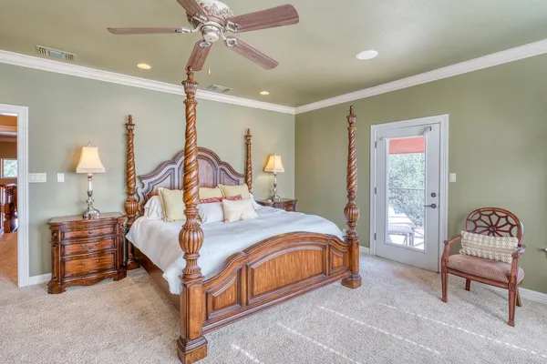 a bedroom with a bed and a chandelier