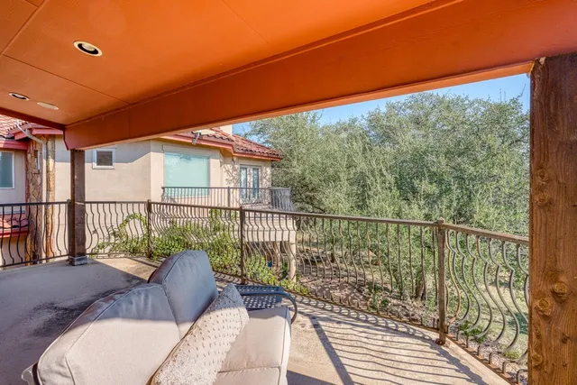 a balcony with view of outdoor space