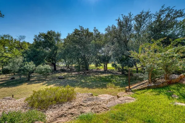a view of a yard with swimming pool
