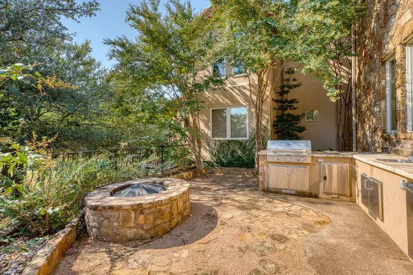 a kitchen with stainless steel appliances granite countertop a sink and a stove