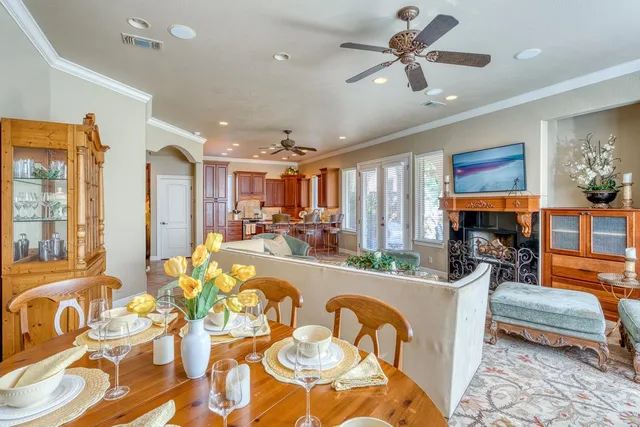 a living room with fireplace furniture and a large window