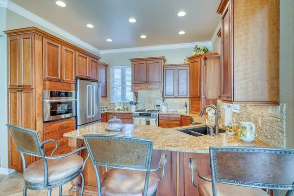 a kitchen with granite countertop a sink and cabinets