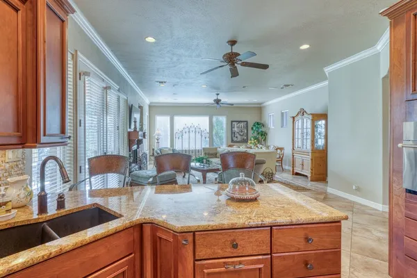 a kitchen with granite countertop a sink and cabinets