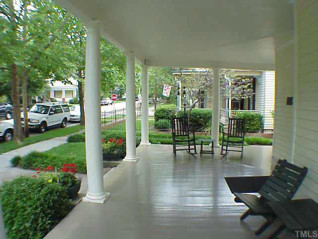 405 Polk Street Raleigh, NC 27604 - Photo 2 of 10 a view of a patio with couches chairs and a floor to ceiling window and garden