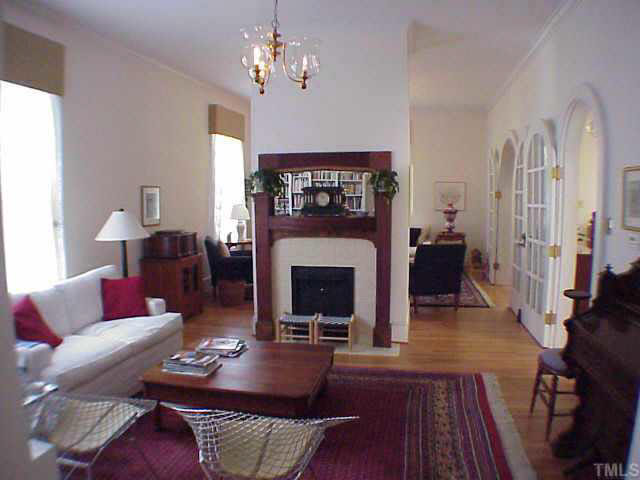 405 Polk Street Raleigh, NC 27604 - Photo 3 of 10 a living room with furniture a fireplace and a chandelier
