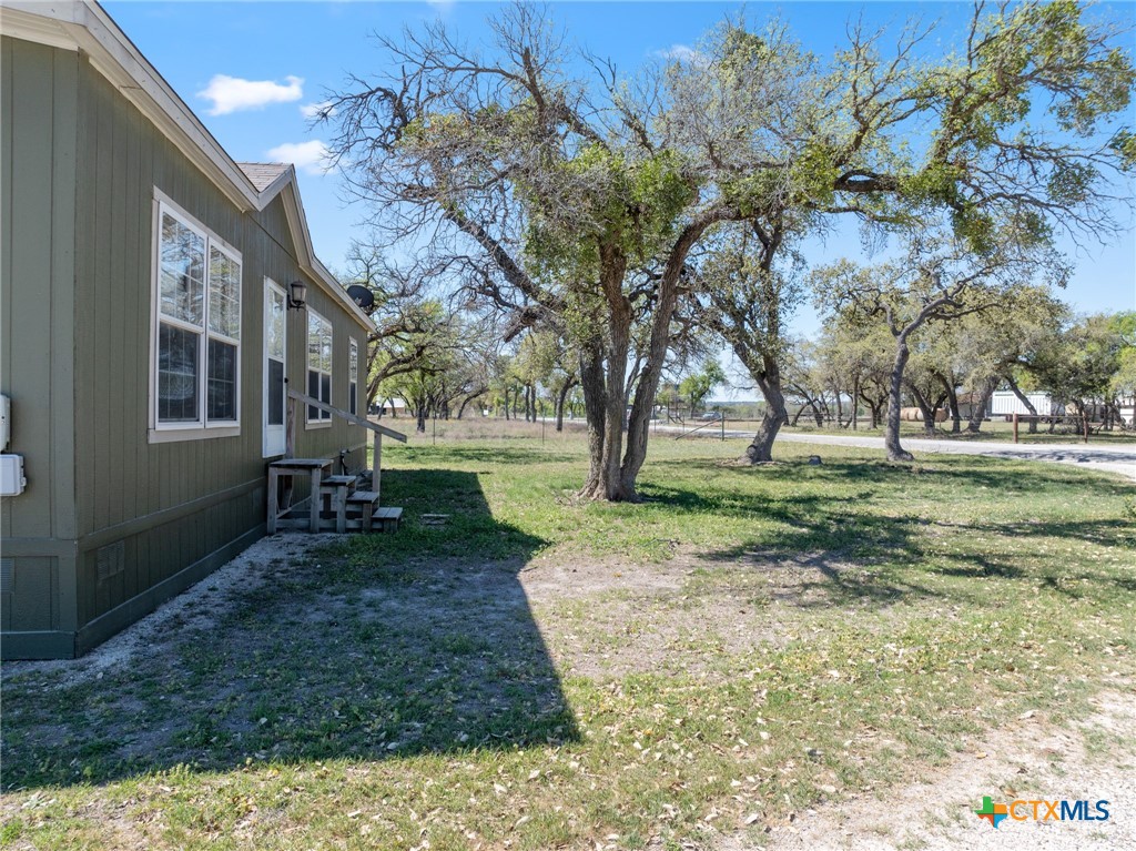 996 County Road 421 Evant, TX 76525 - Photo 16 of 48 a backyard of a house with lots of green space