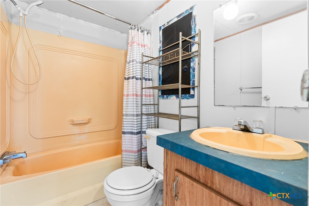 996 County Road 421 Evant, TX 76525 - Photo 30 of 48 a bathroom with a sink a toilet and shower