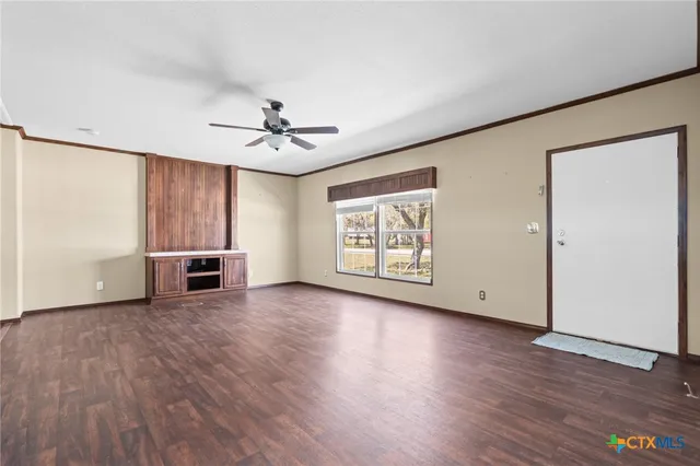a view of a livingroom with furniture wooden floor and window