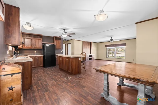 a bathroom with a granite countertop sink a toilet a mirror and shower