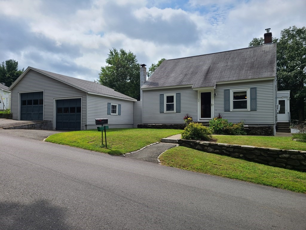 a front view of house with yard and green space