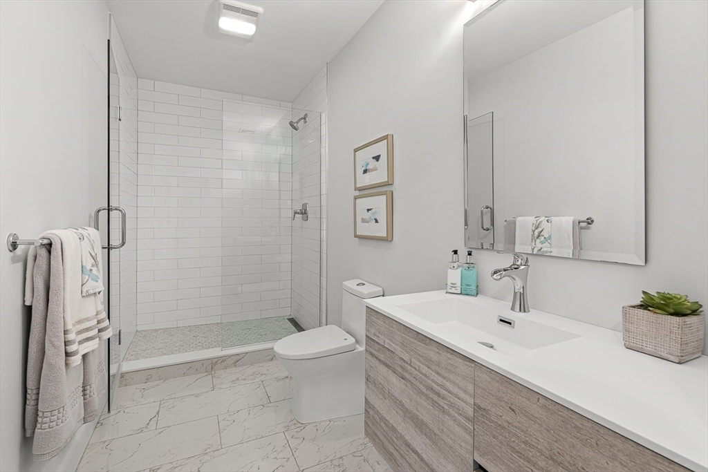 130 Bridle Trail Road Needham, MA 02492 - Photo 14 of 38 a bathroom with a sink a toilet and shower