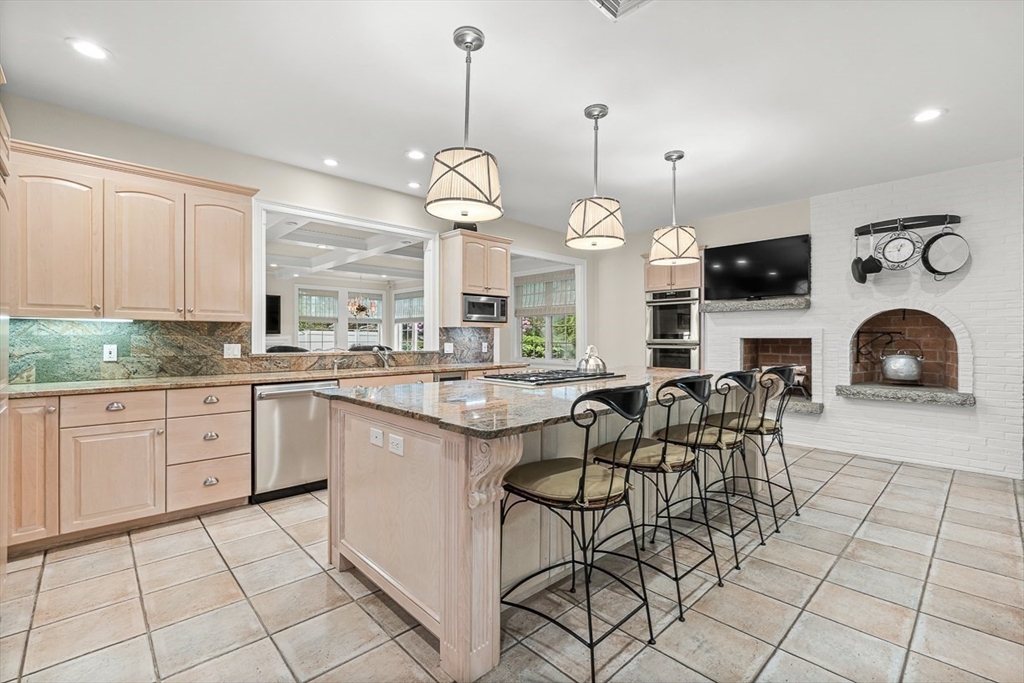 130 Bridle Trail Road Needham, MA 02492 - Photo 8 of 38 a large kitchen with granite countertop a stove a sink a dining table and chair with wooden floor