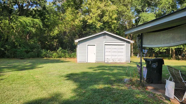 a view of backyard of house with green space