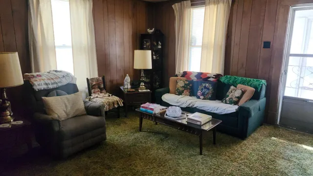 a living room with furniture and a large window