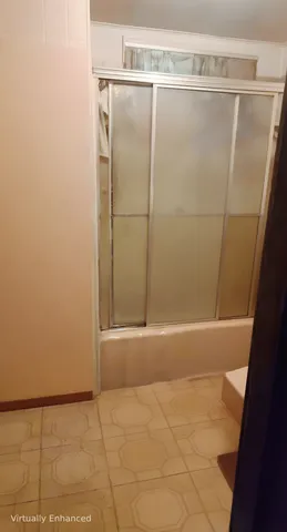 a bathroom with a glass shower door