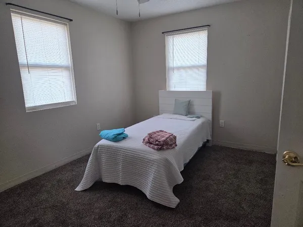 a bedroom with a bed and window