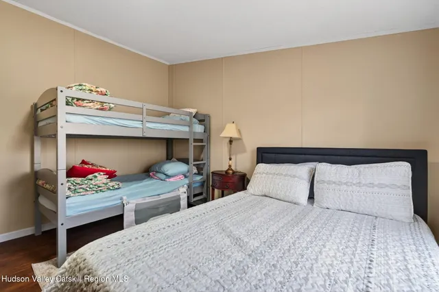 a bedroom with two beds and a chair