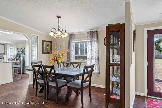a view of a dining room with furniture and window