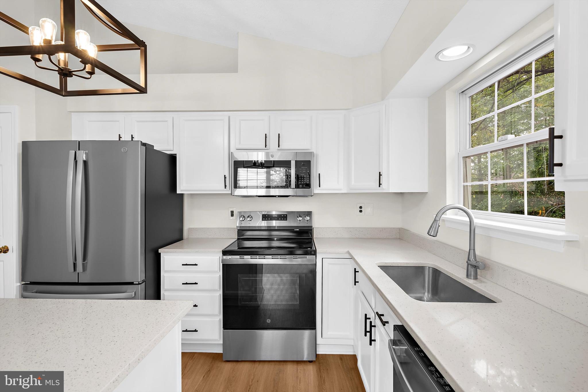 2335 Golden Chapel Road Odenton, MD 21113 - Photo 11 of 37 a kitchen with granite countertop a sink a counter space appliances and cabinets