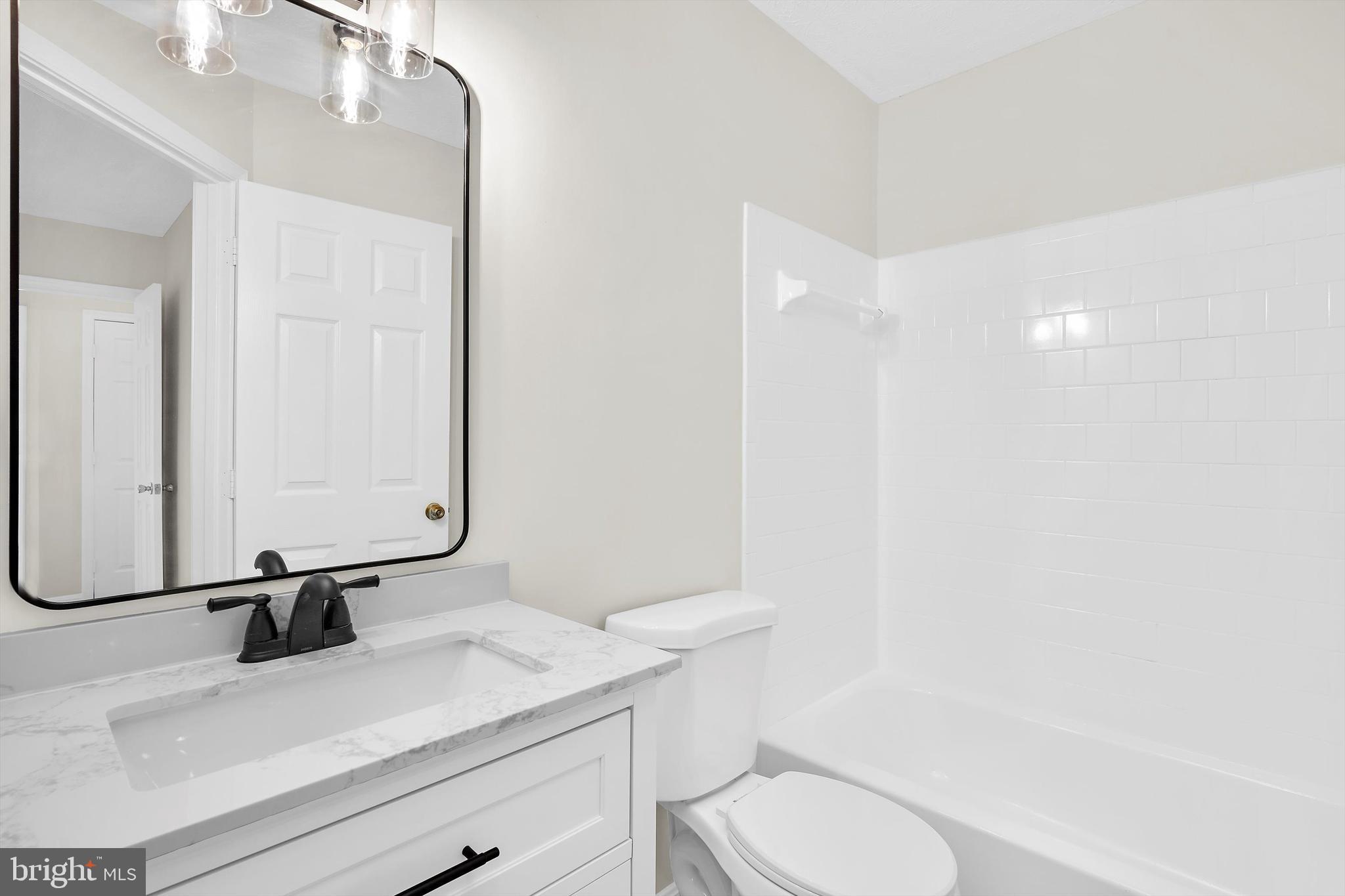 2335 Golden Chapel Road Odenton, MD 21113 - Photo 18 of 37 a bathroom with a sink a toilet and mirror