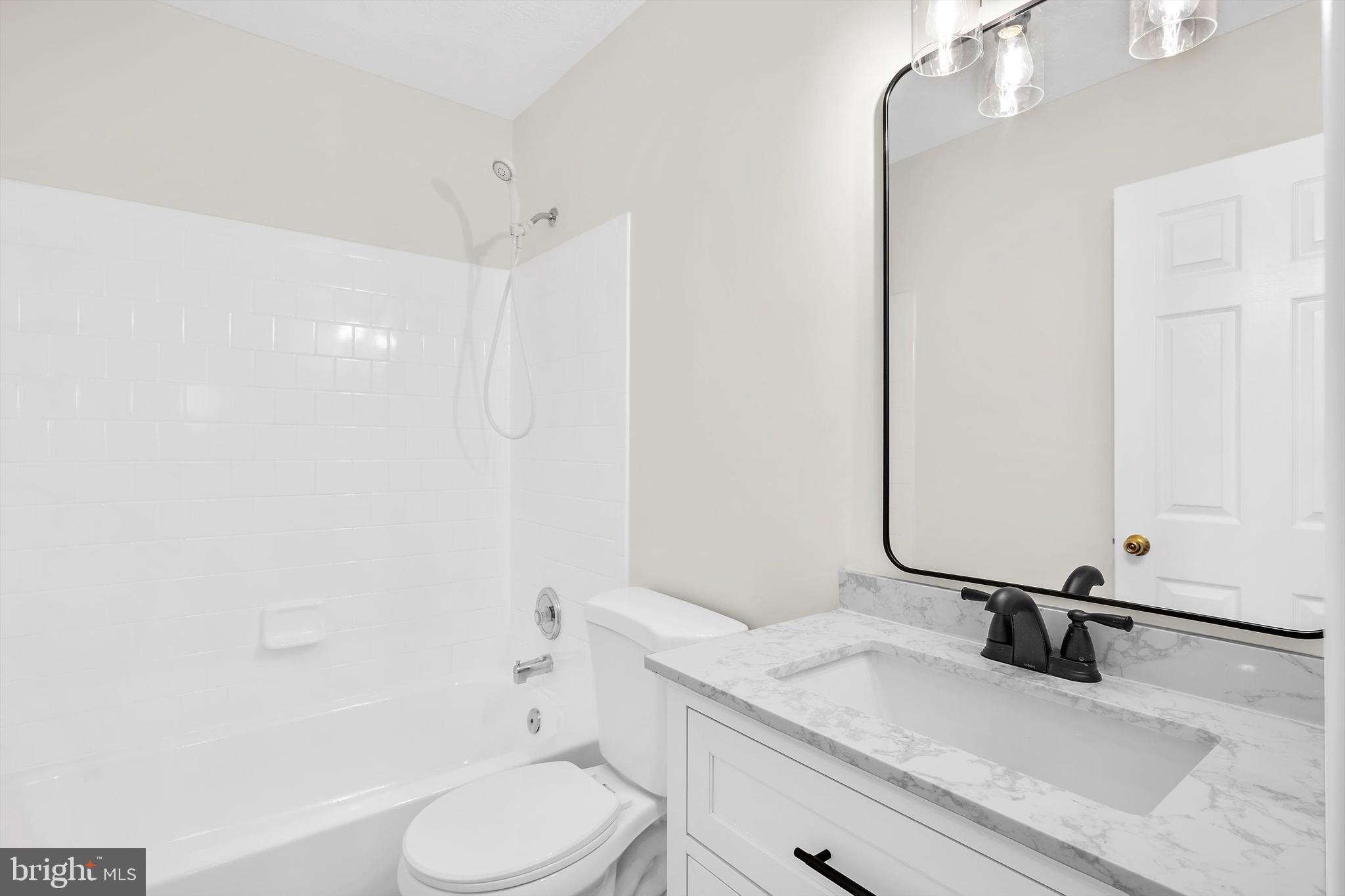2335 Golden Chapel Road Odenton, MD 21113 - Photo 21 of 37 a bathroom with a sink a toilet and a mirror
