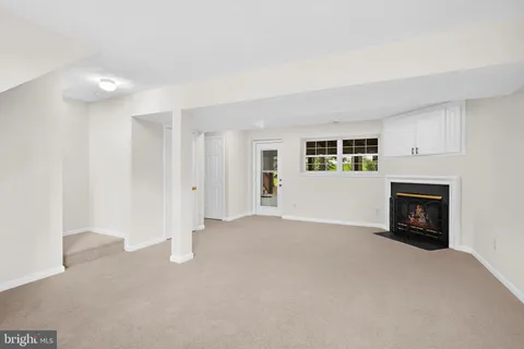 a view of an empty room with a fireplace