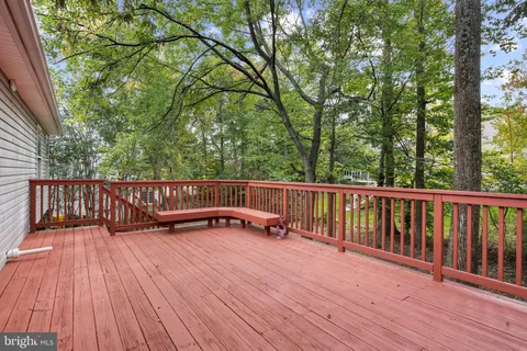 a view of balcony with wooden floor and fence