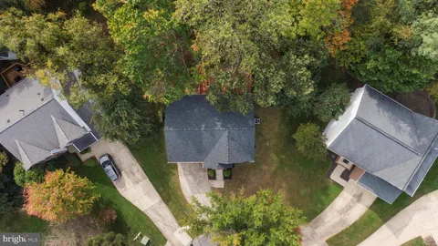 an aerial view of a house with a yard basket ball court and outdoor seating