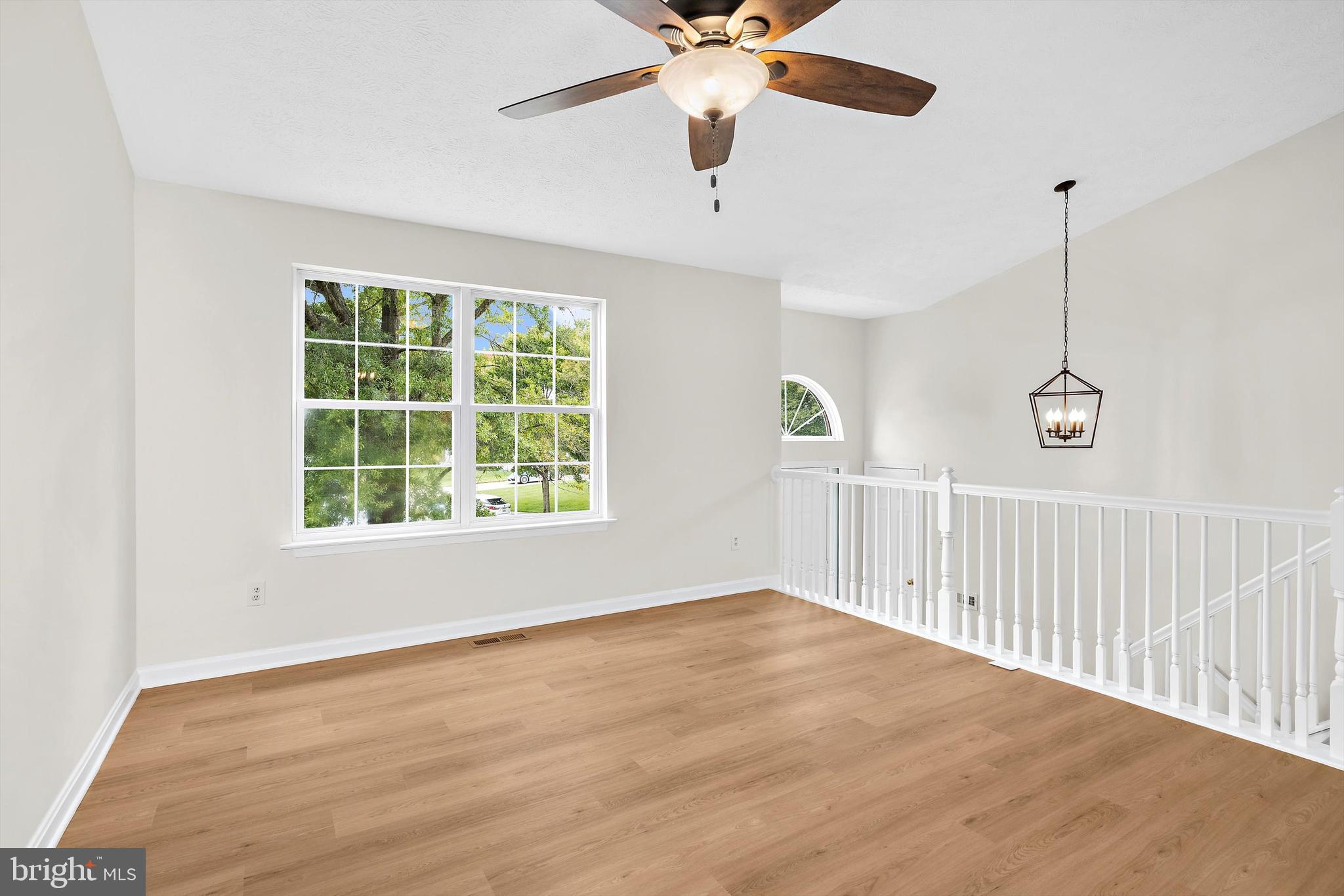 2335 Golden Chapel Road Odenton, MD 21113 - Photo 5 of 37 a view of an empty room with wooden floor and a window