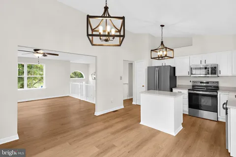 a view of a kitchen with a sink dishwasher and a microwave oven