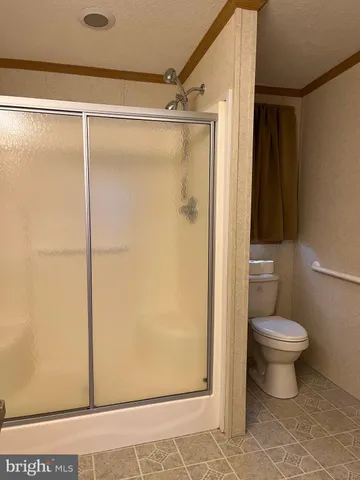 a bathroom that has a toilet shower and a sink