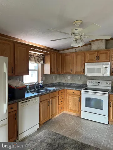 a kitchen with stainless steel appliances granite countertop a stove sink and cabinets