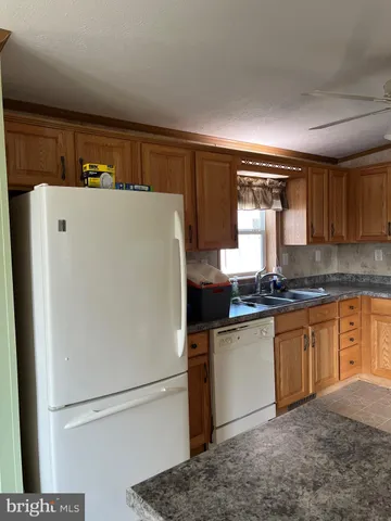 a white refrigerator freezer sitting in a kitchen