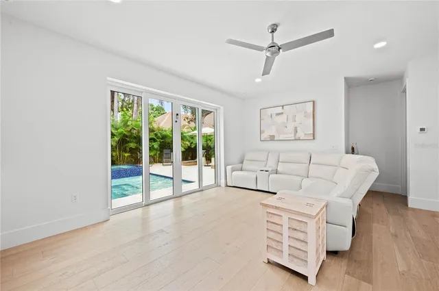 a living room with furniture and kitchen view