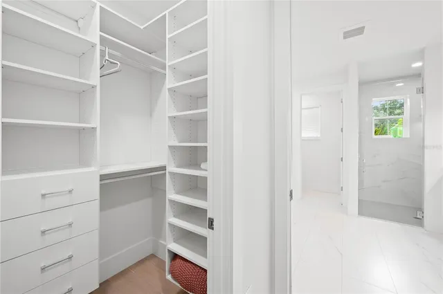 a white bath tub sitting next to a white sink