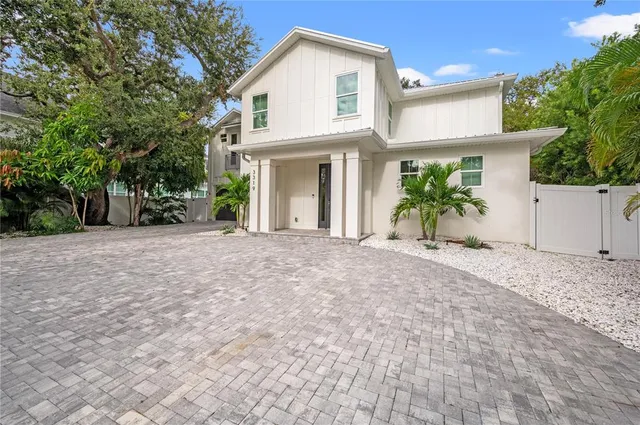 a view of a house with backyard and sitting area