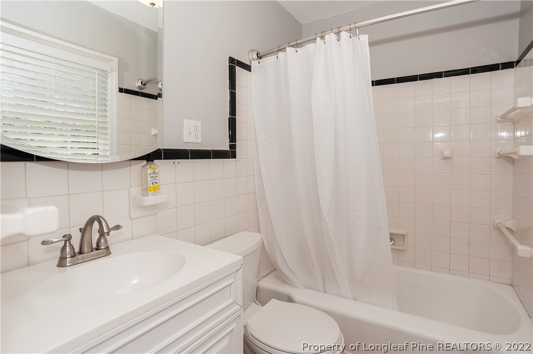 1904 Morganton Road Fayetteville, NC 28305 - Photo 24 of 45 a bathroom with a sink toilet and shower