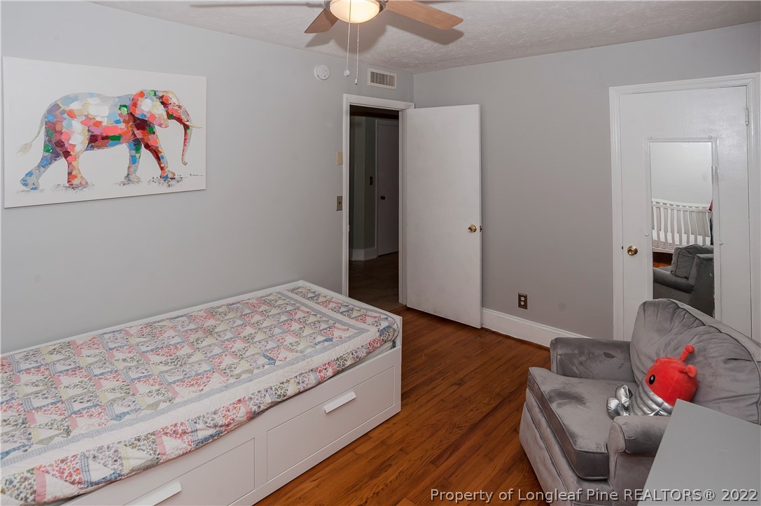 1904 Morganton Road Fayetteville, NC 28305 - Photo 28 of 45 a bedroom with a bed and a chandelier