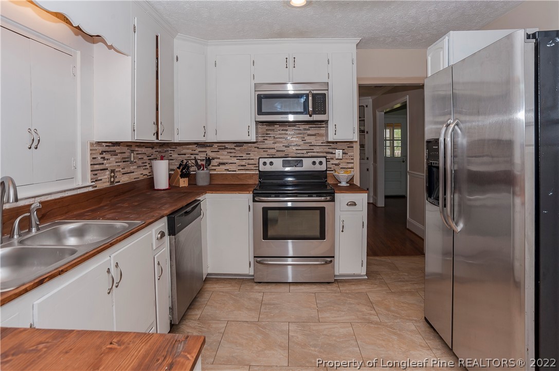 1904 Morganton Road Fayetteville, NC 28305 - Photo 45 of 45 a kitchen with a sink stove and refrigerator