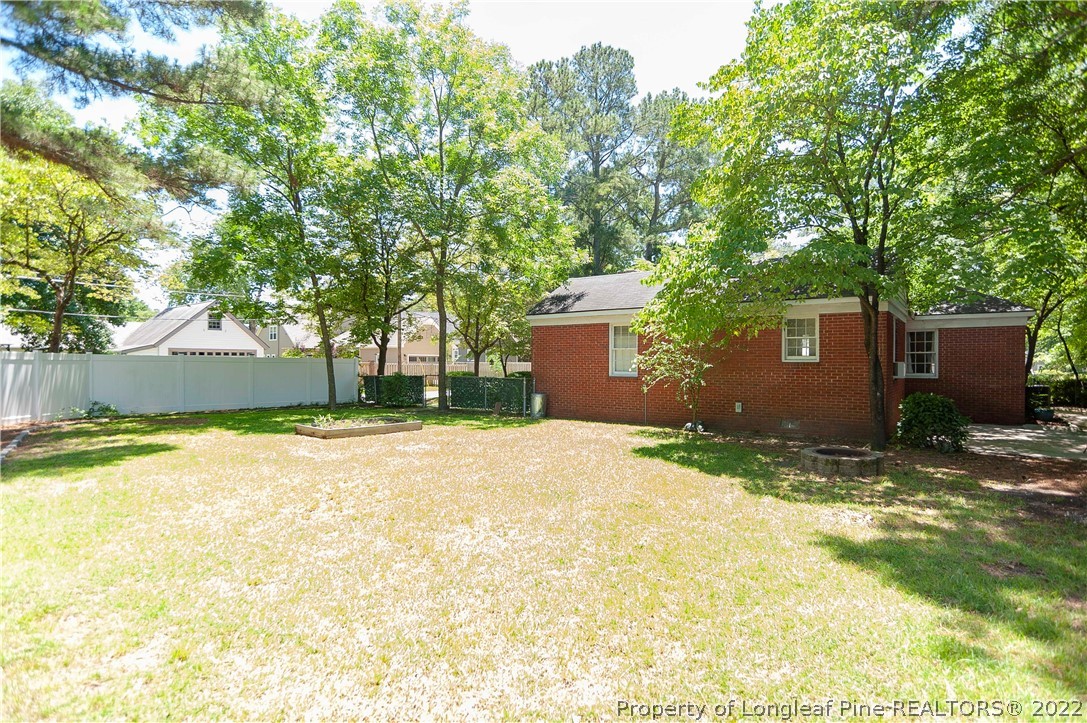 1904 Morganton Road Fayetteville, NC 28305 - Photo 10 of 45 a backyard of a house with a garden and tree