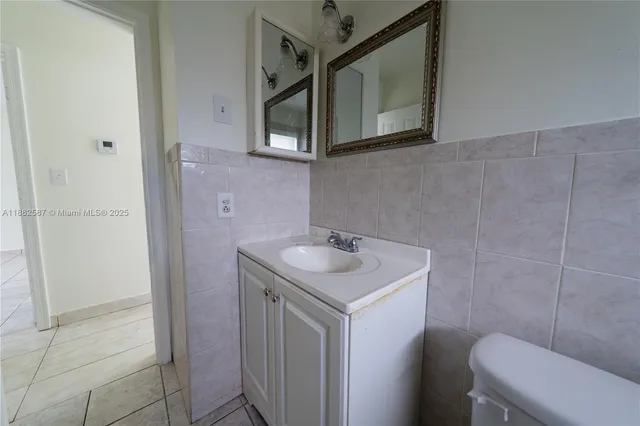 a bathroom with a sink toilet and mirror