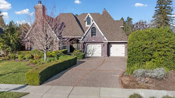 a front view of a house with a garden
