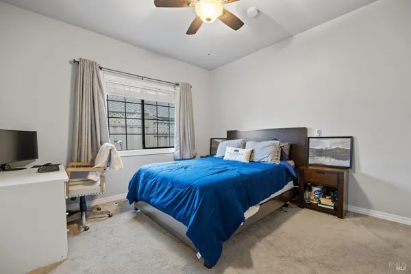 a living room with furniture a table and kitchen view