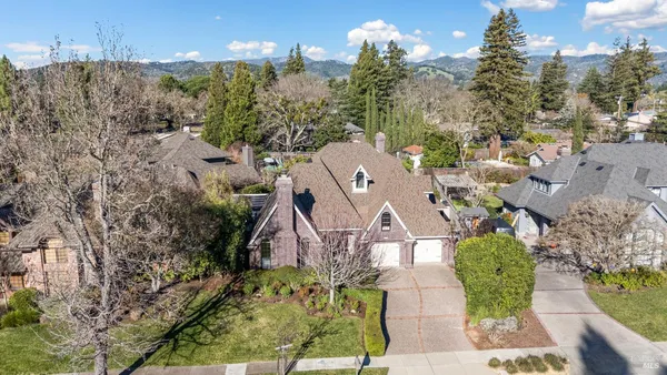 a view of a livingroom with wooden floor and furniture