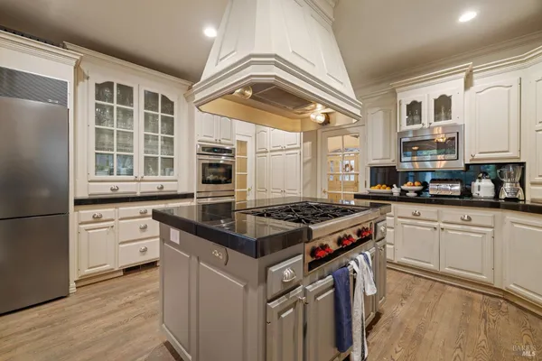 a living room with furniture a fireplace and windows