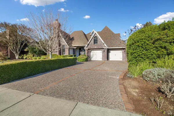 a view of a house with swimming pool and sitting area
