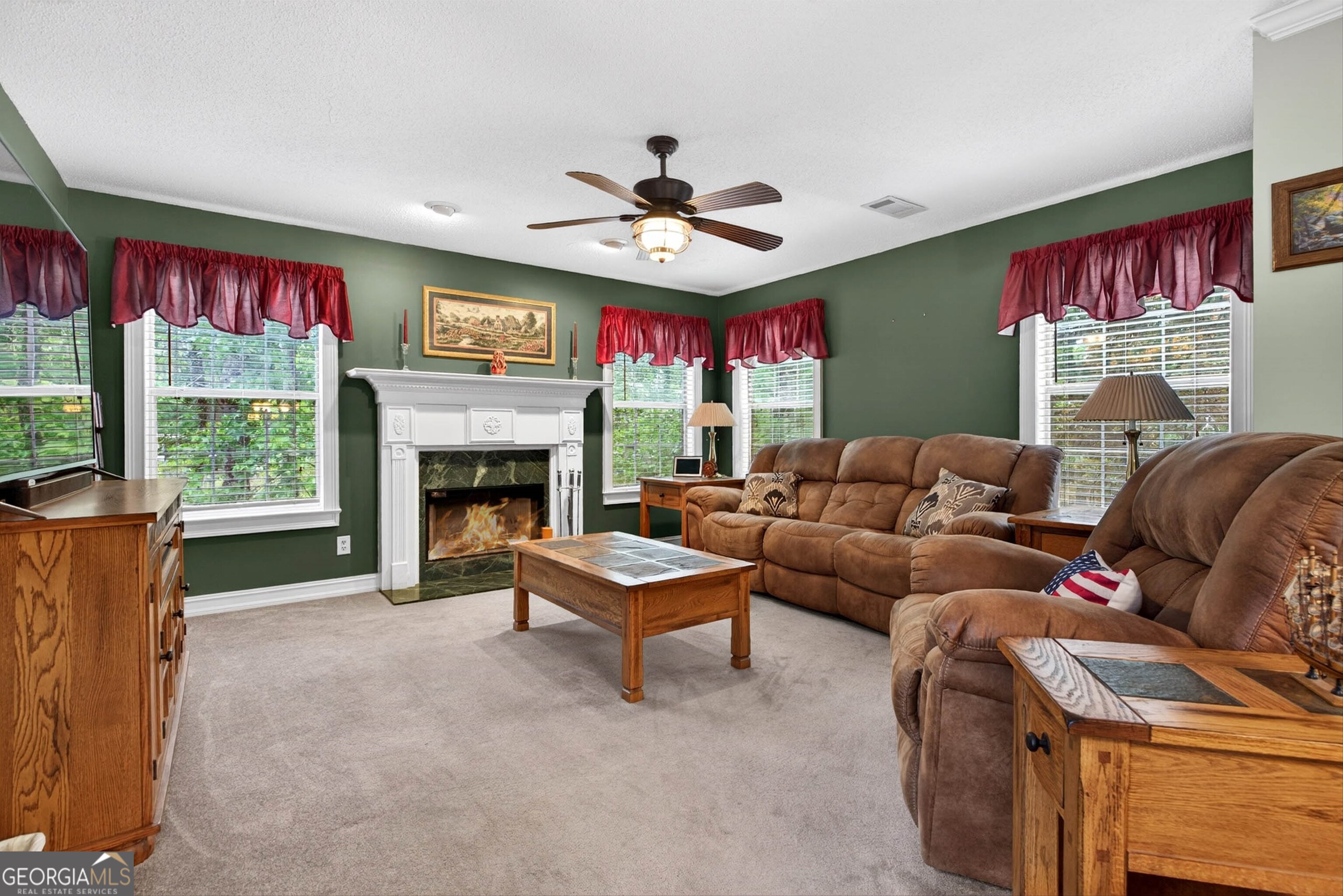 101 Emerald Lane Hampton, GA 30228 - Photo 11 of 72 a living room with furniture a fireplace and a large window