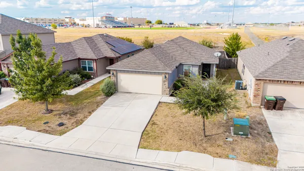 an aerial view of house with yard and ocean view
